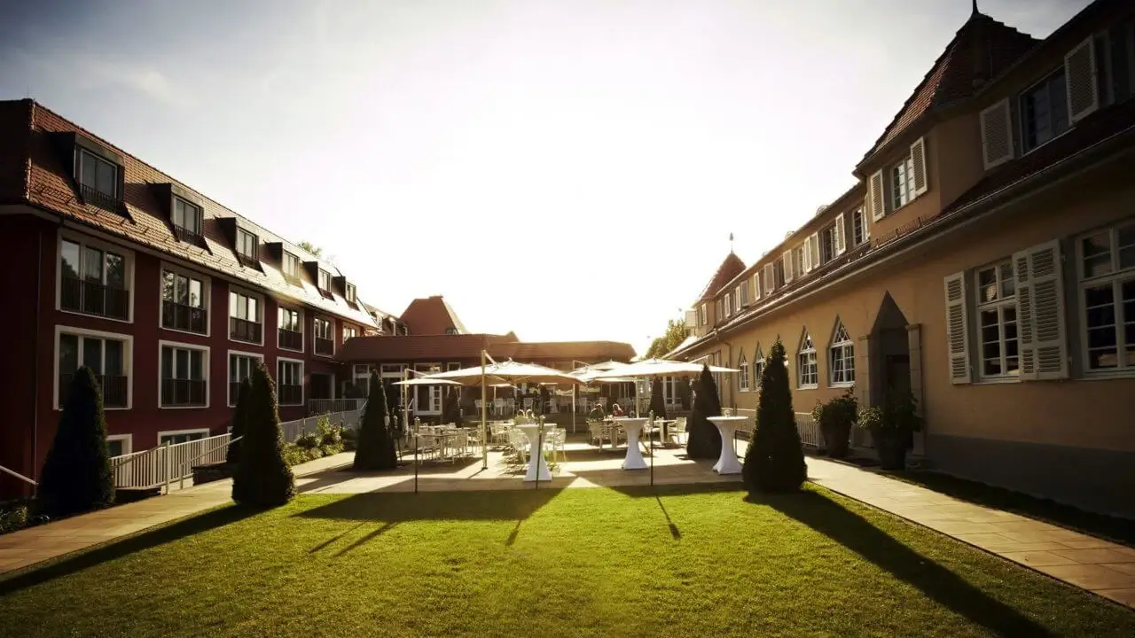 Eine stilvolle Outdoor-Eventlocation mit eleganter Terrasse und sonnigem Ambiente.